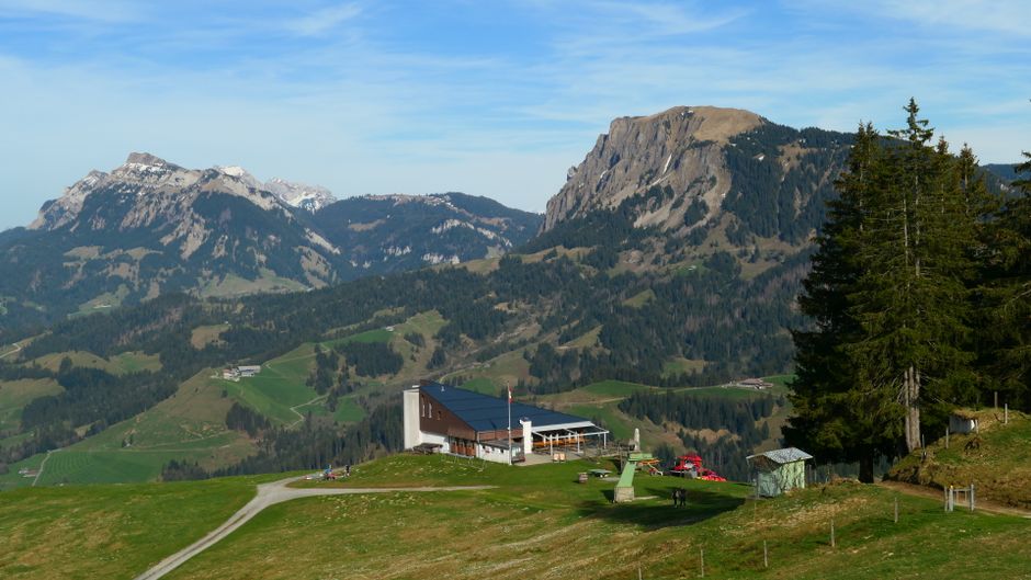 Breathtaking alpine landscape in Entlebuch, Switzerland with a rustic cabin and majestic mountains.